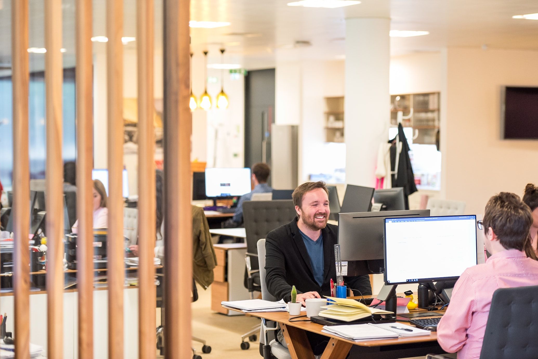 Two employees working simultaneously on their caption project