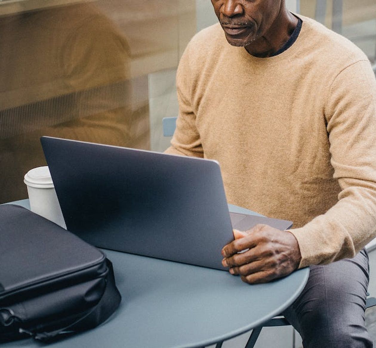 A man making new lessons for his online students using captions